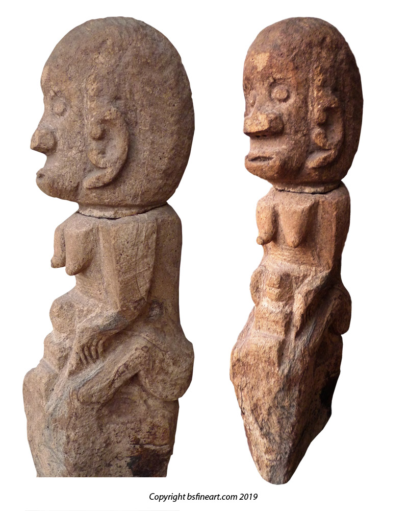 Batak Toba stone female fertility figure clutching a newly born child between her legs