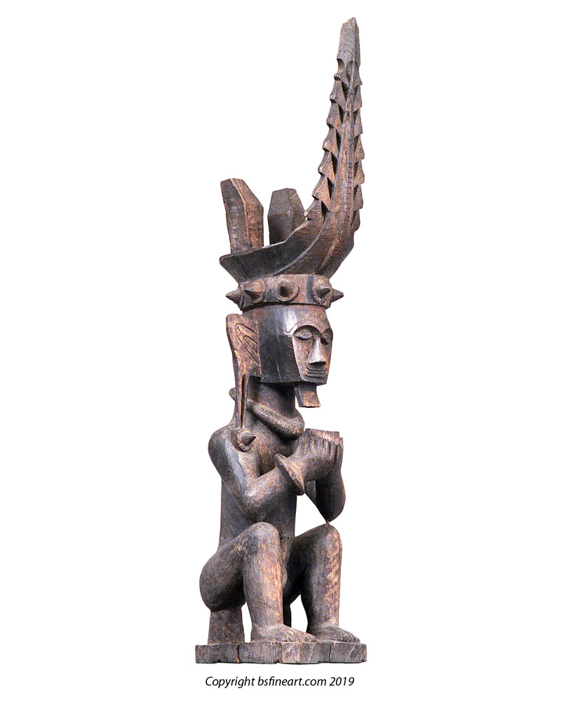 Nias Island male ancestor figure seated and holding a cup in both hands