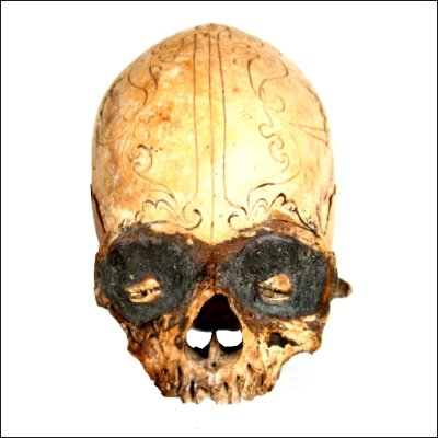 Dayak human trophy skull with finely carved cranial area and eyes set with pitch