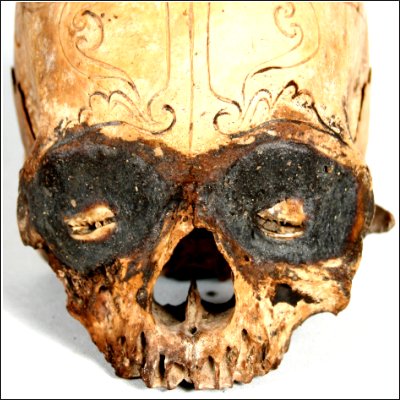 Dayak human trophy skull with finely carved cranial area and eyes set with pitch