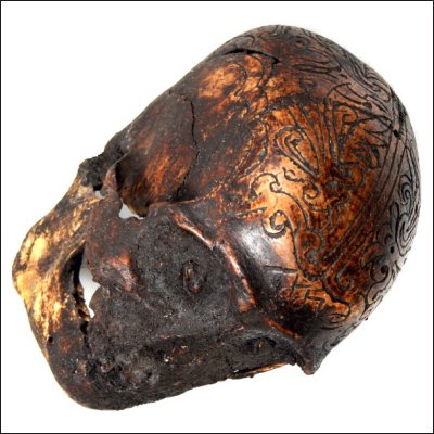 Dayak human trophy skull with carved cranium and eyes set with pitch